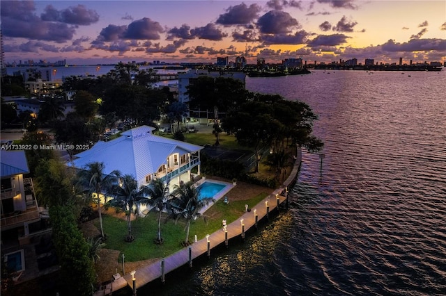 aerial view at dusk with a water view