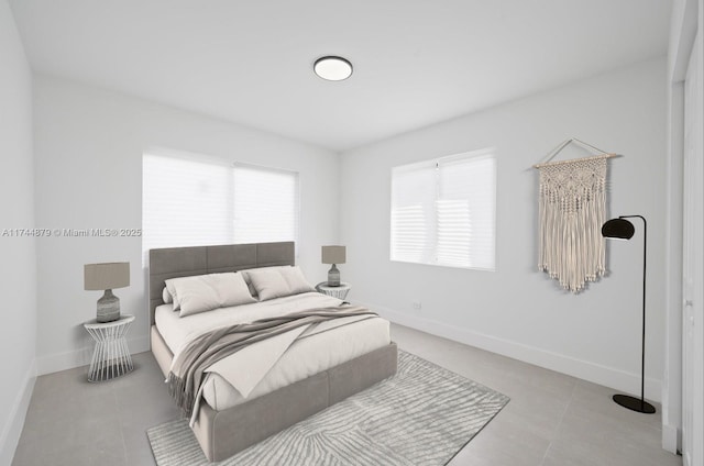 bedroom featuring baseboards and tile patterned floors