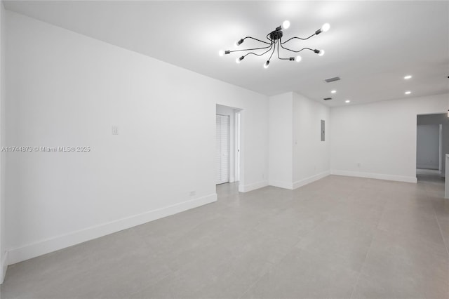 empty room featuring visible vents, baseboards, a chandelier, and recessed lighting