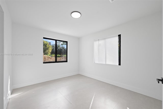 spare room featuring baseboards