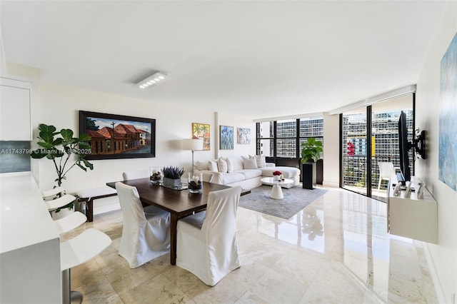 dining area featuring a wall of windows