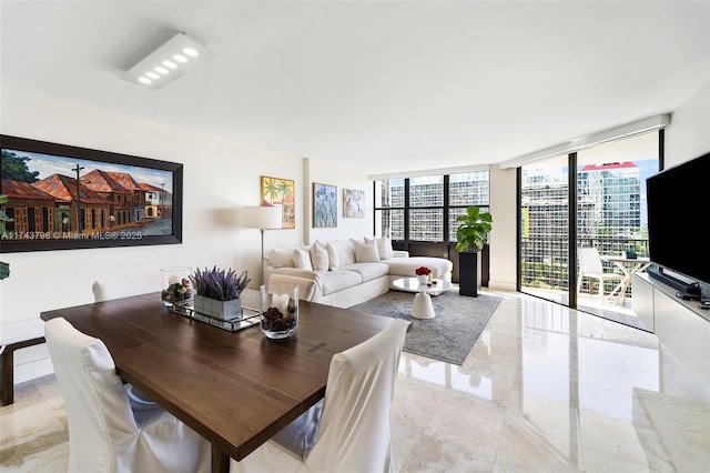 dining area featuring a wall of windows