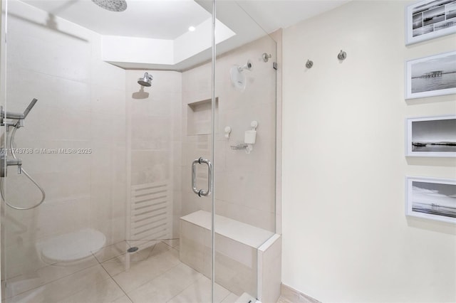 bathroom featuring an enclosed shower and tile patterned flooring