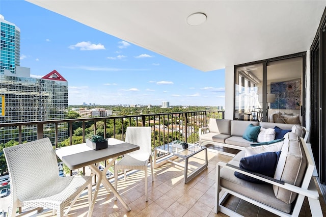 balcony featuring a city view and outdoor lounge area