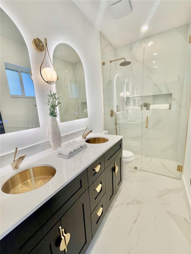 bathroom with vanity, toilet, and an enclosed shower