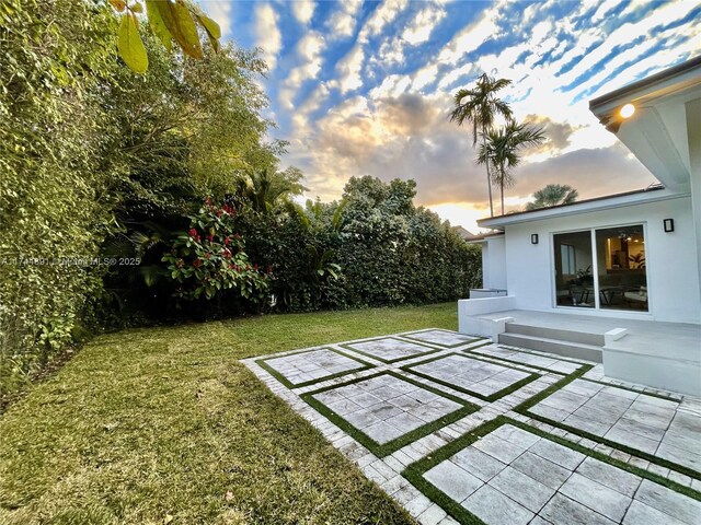 yard at dusk with a patio