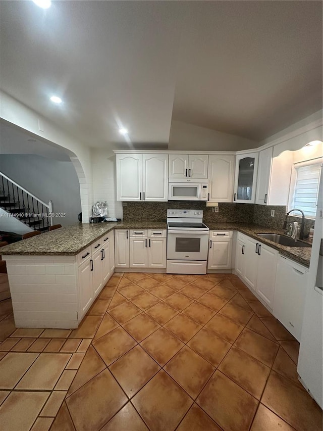 541 NE 199th Ln Unit 2X, Miami, FL 33179 - kitchen featuring a sink, light tile patterned floors, white appliances, decorative backsplash, and white cabinetry
