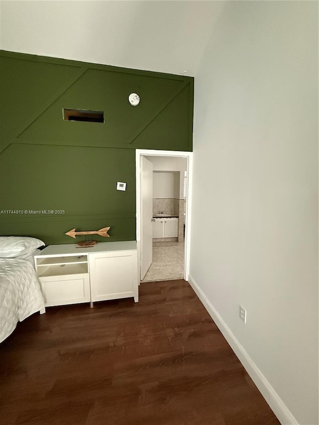 541 NE 199th Ln Unit 2X, Miami, FL 33179 - unfurnished bedroom with baseboards and dark wood-type flooring