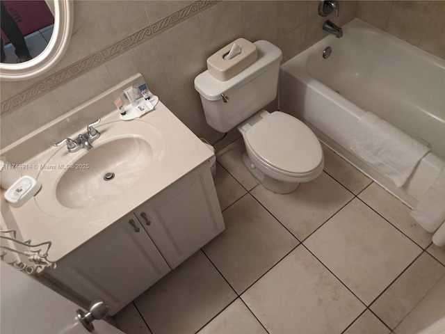 bathroom featuring tile patterned flooring, vanity, tile walls, and toilet