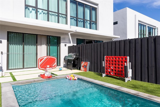 view of pool featuring area for grilling