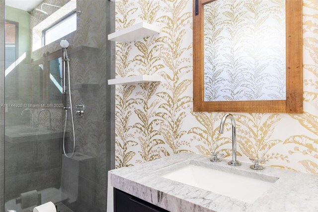 bathroom with vanity and tiled shower