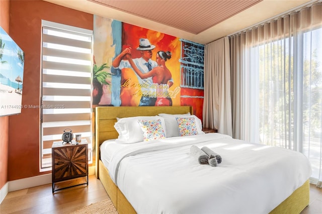 bedroom featuring wood ceiling and light hardwood / wood-style floors