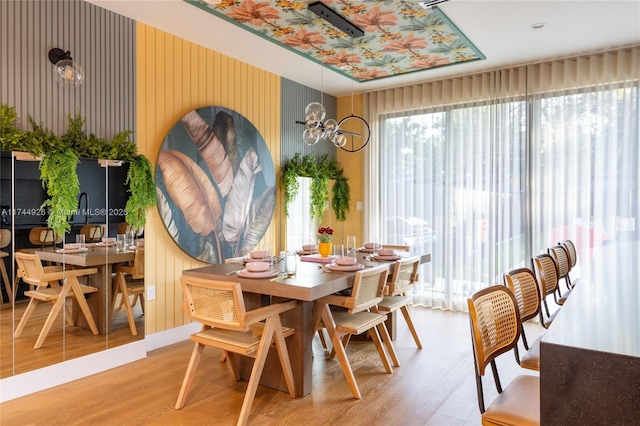 dining space with a notable chandelier and light wood-type flooring