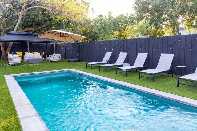 view of pool with a gazebo, an outdoor hangout area, and a lawn