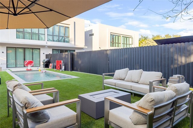 view of yard featuring an outdoor living space, a fenced in pool, and a patio