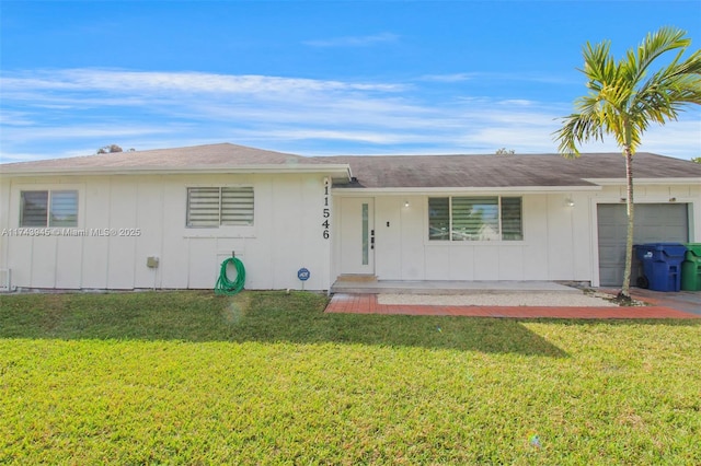 single story home featuring a garage and a front lawn