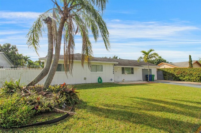 rear view of property featuring a lawn