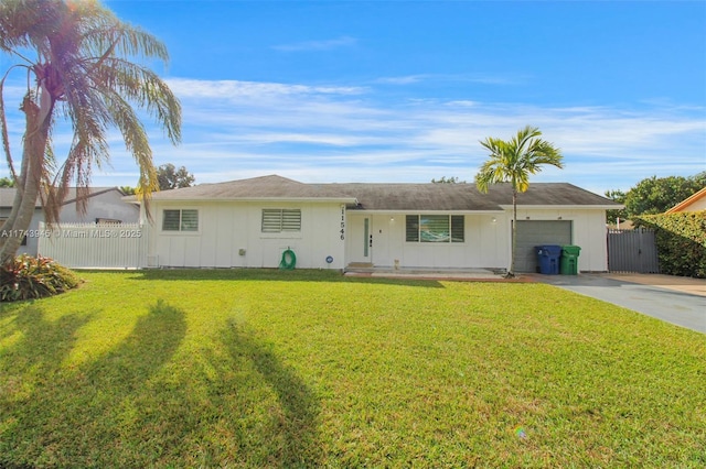 ranch-style home featuring a garage and a front lawn