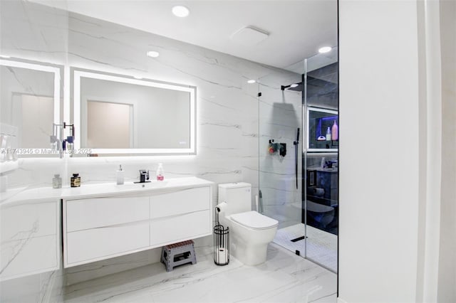 bathroom featuring vanity, toilet, a shower with door, and tile walls