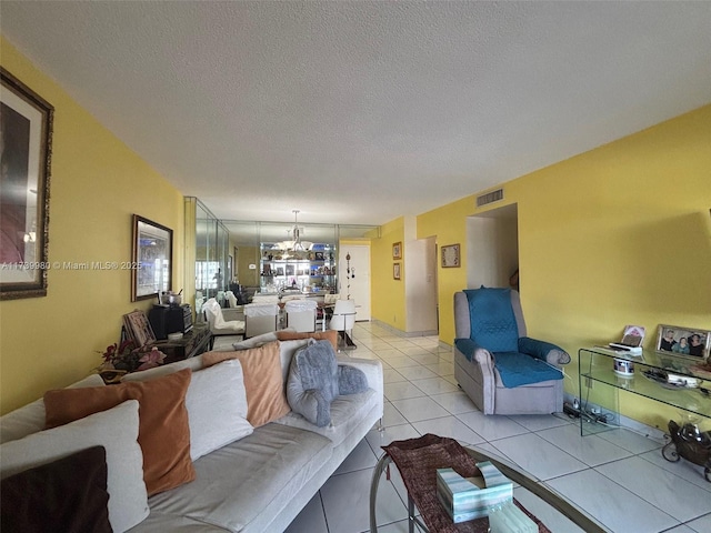 living room with a textured ceiling and light tile patterned floors