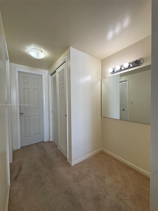 hallway with carpet floors