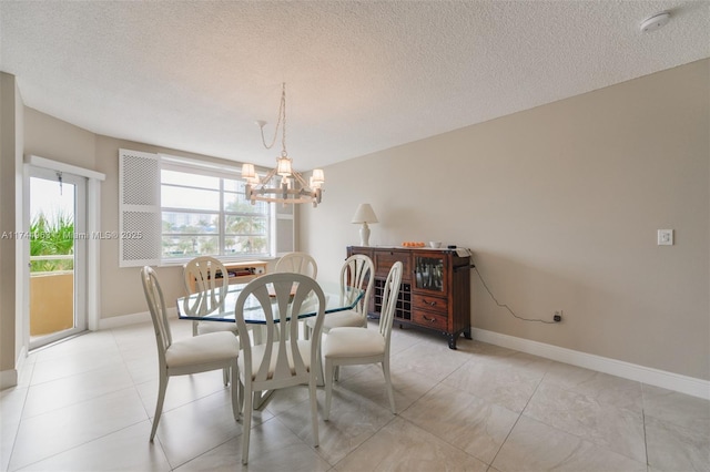 1950 S Ocean Dr Unit 2E, Hallandale Beach, FL 33009 - dining space featuring a textured ceiling, baseboards, and a notable chandelier