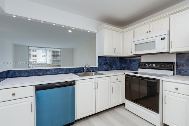 kitchen featuring range with electric cooktop, white cabinetry, dishwasher, sink, and backsplash