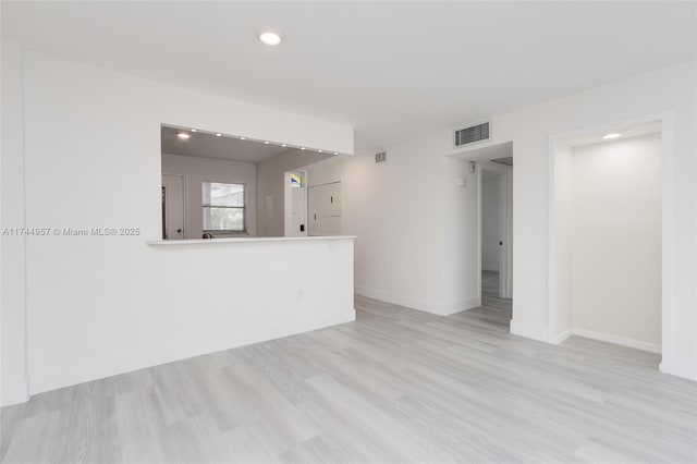 spare room with light wood-type flooring