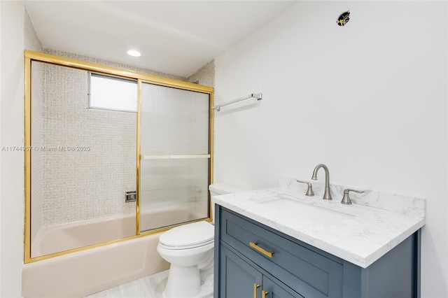 full bathroom featuring enclosed tub / shower combo, vanity, and toilet