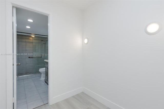 bathroom featuring vanity, toilet, and an enclosed shower