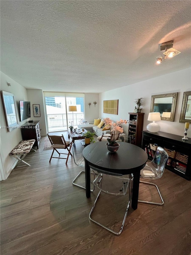 dining area featuring dark hardwood / wood-style floors and a textured ceiling