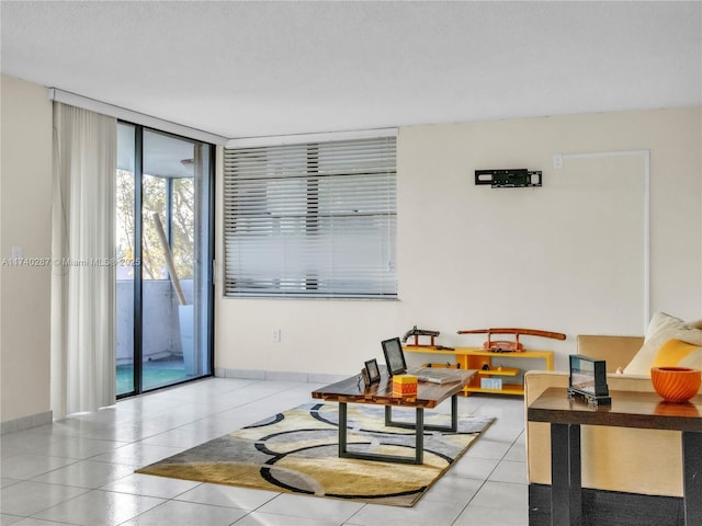 tiled living room with expansive windows and a textured ceiling