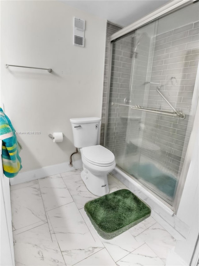 bathroom featuring toilet and an enclosed shower