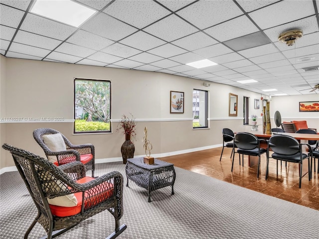 living room with plenty of natural light and a paneled ceiling