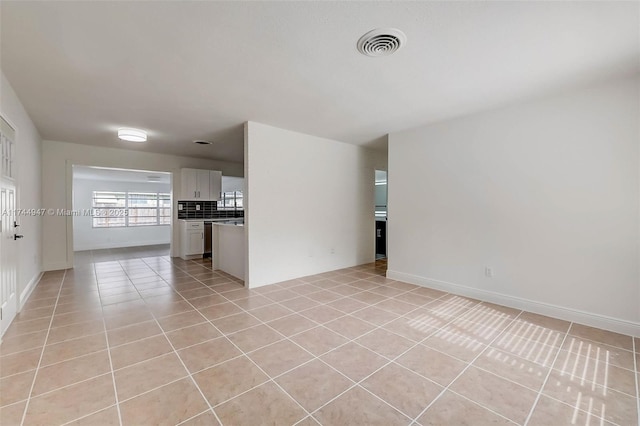 empty room with light tile patterned floors