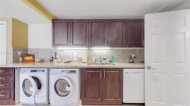 kitchen featuring separate washer and dryer, sink, tasteful backsplash, and dishwasher