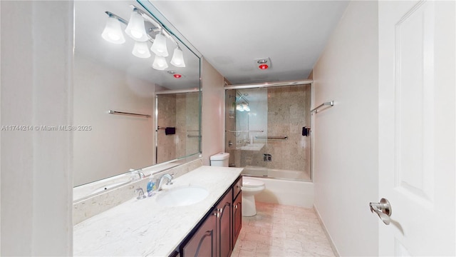 full bathroom with enclosed tub / shower combo, vanity, and toilet