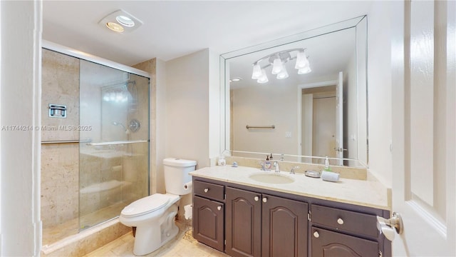 bathroom with vanity, a shower with shower door, and toilet