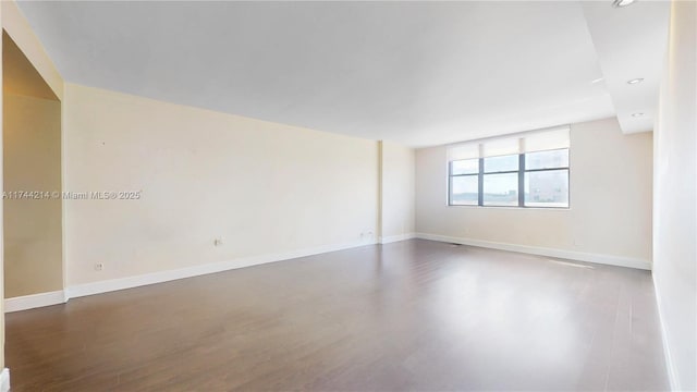 empty room featuring dark hardwood / wood-style floors