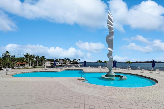 view of swimming pool with a water view