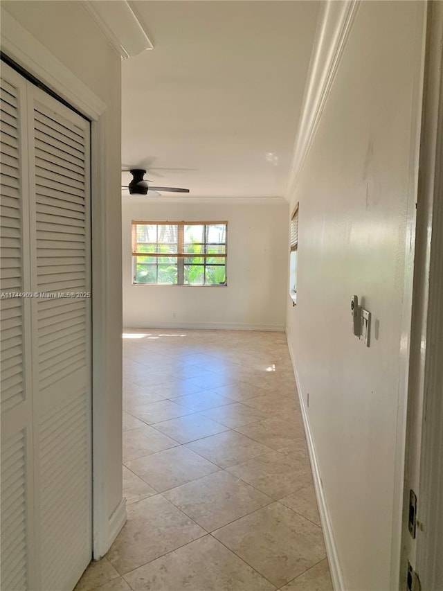 hallway featuring light tile patterned flooring and ornamental molding