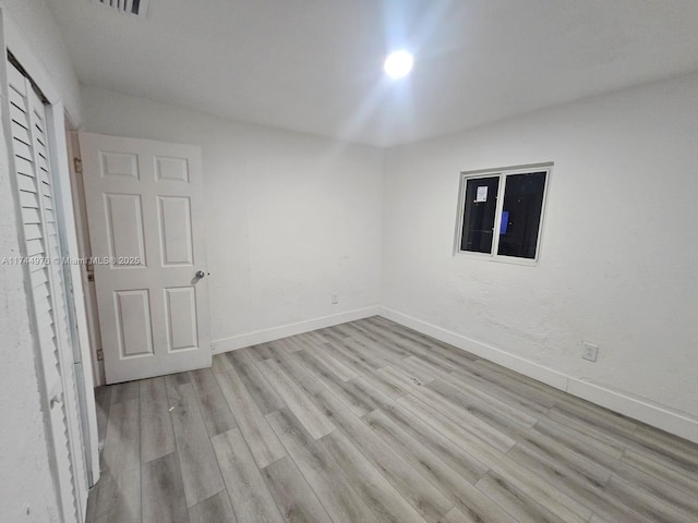 empty room with light hardwood / wood-style flooring