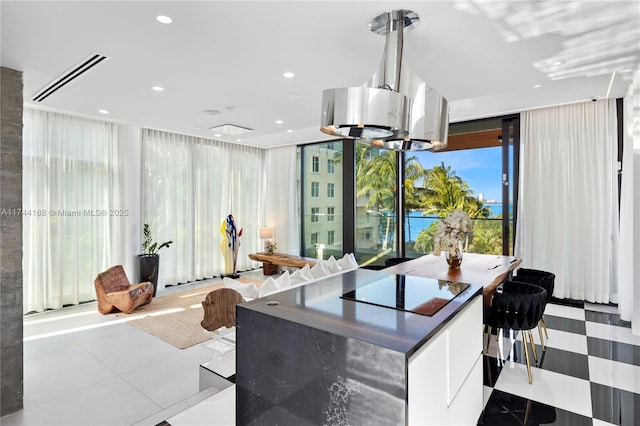 kitchen with light tile patterned floors and white cabinetry