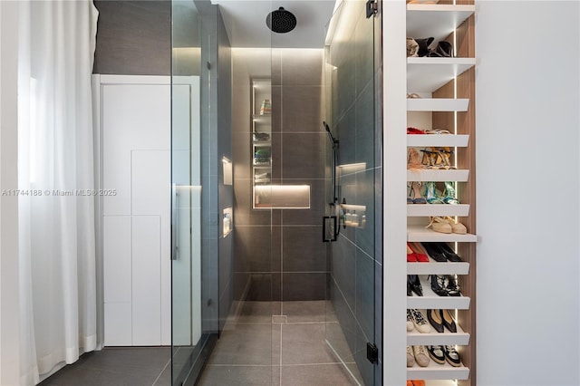 bathroom with tile patterned flooring and an enclosed shower