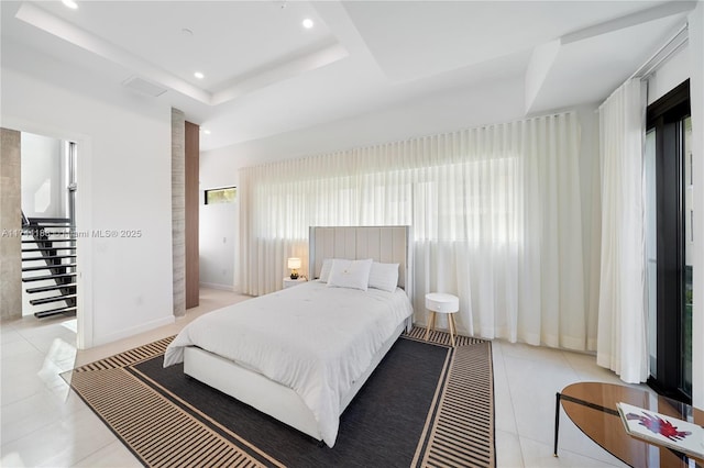 tiled bedroom with a raised ceiling