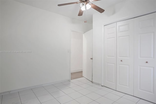 unfurnished bedroom featuring light tile patterned floors, ceiling fan, and a closet