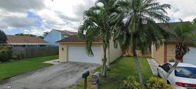 view of front of house with a garage and a front yard