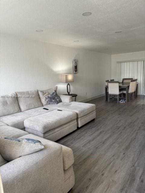 living room featuring dark hardwood / wood-style floors and a textured ceiling