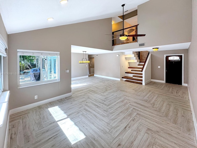 unfurnished living room featuring ceiling fan, high vaulted ceiling, and light parquet flooring