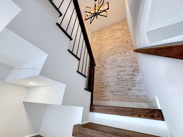 stairway with a chandelier